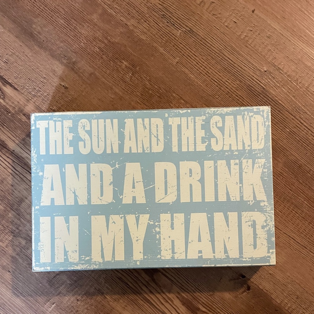 “The sun and the sand and a drink in my hand” sign